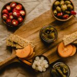 Deska z kiszonymi ogórkami, oliwkami i pieczywem chrupkim