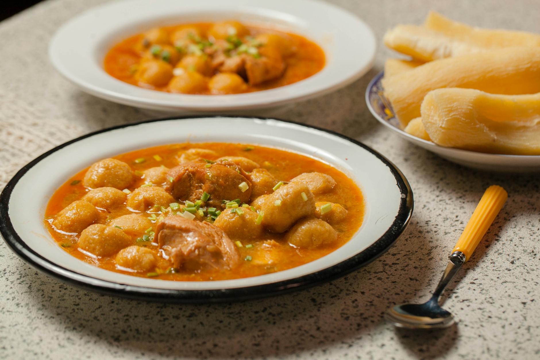 Talerz domowego rosołu z kluskami na drewnianym stole